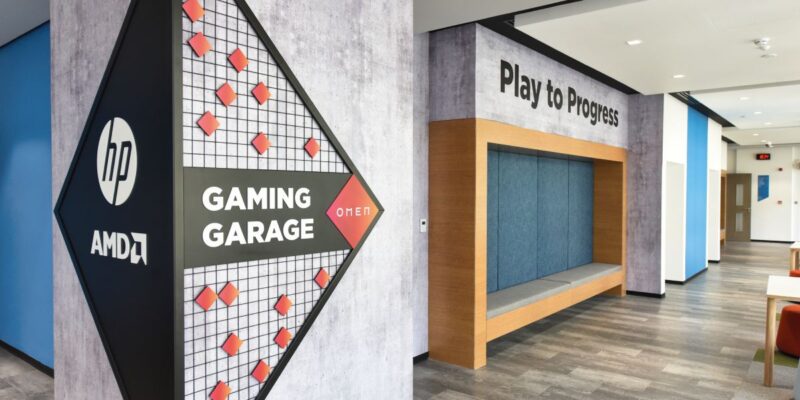 A sign that says "Gaming Garage" is on the wall.