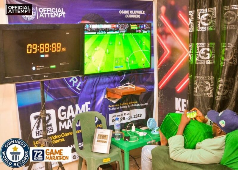 A man is sitting in a chair playing a video game.